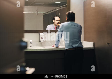 L'homme d'affaires se brosser les dents après le déjeuner en salle de bains Bureau Banque D'Images
