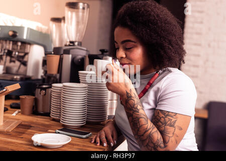 Femme agréable odeur de son café Banque D'Images