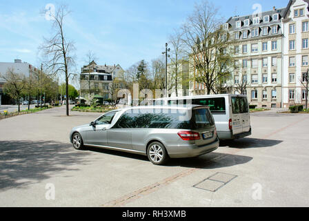 PARIS, FRANCE - Apr 17, 2013 : Mercedes-Benz corbillard véhicule stationné en face de l'église à côté d'une fourgonnette pour des services funéraires dans le centre ville Banque D'Images