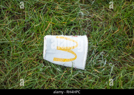Jeter des ordures jetées McDonald's cup boissons papier à gauche sur l'herbe givrée dans la campagne anglaise Banque D'Images