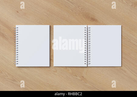 Ouverte et Fermée en blanc spirale verticale des blocs-notes sur fond de bois. Avec chemin de détourage autour de notebooks pages. 3d illustration