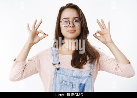 Tout est ok. Confiant libre professional dans des combinaisons et des lunettes d'assurer les travaux en cours grand, montrant bien geste avec l'auto-assurance Banque D'Images