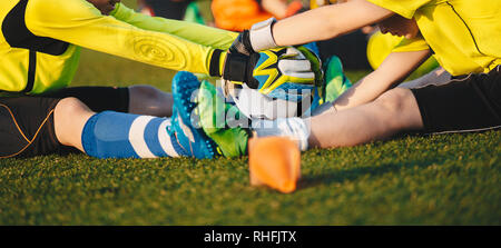 Gardien de football pour les enfants l'amélioration des compétences sur la formation du football. Session de formation de gardien de football. Les garçons au foot ball Holding Gants. Youth Soccer Rendez Banque D'Images