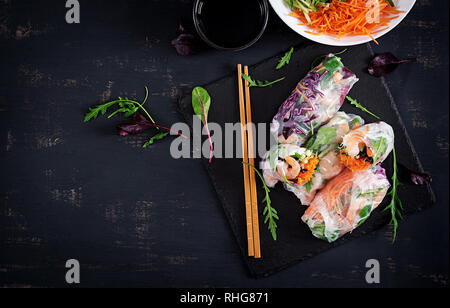 Végétarien vietnamien des rouleaux de printemps avec crevettes épicées, les crevettes, les carottes, le concombre, le chou rouge et le riz et nouilles. Les fruits de mer. Repas savoureux. Vue de dessus, la télévision Banque D'Images