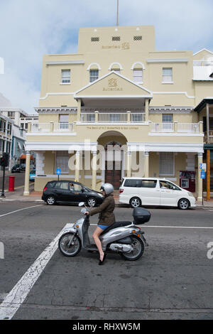 Hamilton, Bermudes - Mars 20, 2016 : femme en scooter sur rue. Femme sur un cyclomoteur sur paysage de rue. Rapide et gratuit femme. En transport pour femme confiante. Le voyage. Banque D'Images