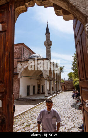 Istanbul, Turquie : un homme marche sous l'arche d'entrée de la mosquée de la petite Sainte-sophie anciennement l'église byzantine des saints Serge et Bacch Banque D'Images