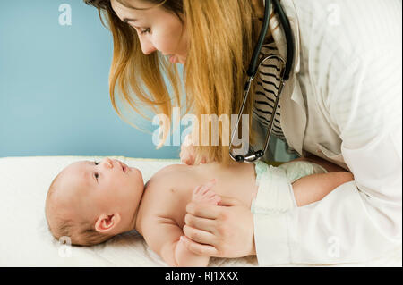 Médecin faisant des exercices avec un nonborn bébé sur un fond isolé. Concept de la médecine et de la santé Banque D'Images