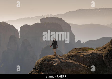 Femme debout sur le quartier historique des Rocks des météores en Grèce. Banque D'Images