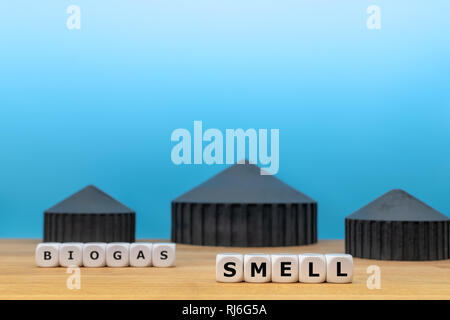 Formulaire dés les mots 'BIOGAZ' et 'SMELL' en face d'un modèle d'une usine de biogaz. Banque D'Images