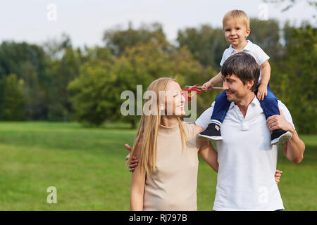 Famille heureuse ensemble dans le parc d'été. Banque D'Images