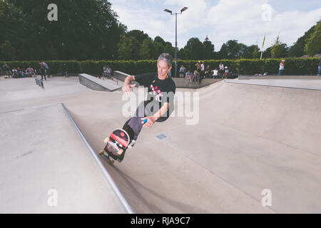 Un homme au niveau de patinage Skatepark à Brighton, East Sussex, Angleterre. Banque D'Images