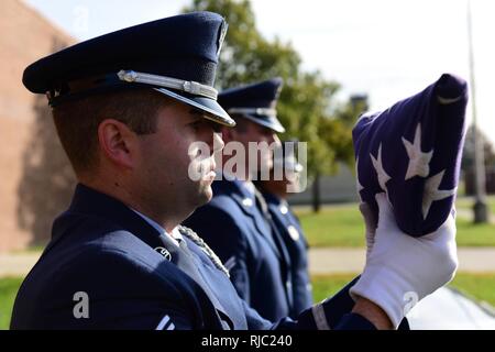 Les cadres supérieurs de l'US Air Force Airman Jeffrey Pipkin, un membre de l'équipe du Whiteman Air Force Base sur la garde d'honneur robes un drapeau pendant une simulation de funérailles à Whiteman Air Force Base, Mo., Novembre 2, 2016. Composée de membres de différentes unités tout au long de la base, la garde d'honneur de Whiteman et funérailles effectue les honneurs militaires à l'appui de 99 comtés du Missouri et 19 comtés du Kansas, couvrant plus de 70 000 kilomètres carrés, l'un des plus grands domaines de responsabilité dans toutes les forces aériennes du Global Strike Command. Banque D'Images