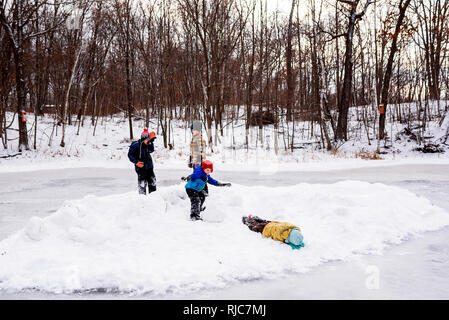 Quatre enfants de marcher sur un lac gelé, Wisconsin, United States Banque D'Images