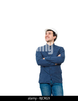 Jeune homme décontracté portant des ingénieur helmet holding mains croisées de la recherche des isolés sur fond blanc avec soin. Banque D'Images