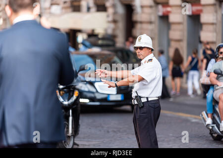 Rome, Italie - le 4 septembre 2018 : Un Italien homme de trafic dans la rue de la ville l'extérieur permanent agent de police carabinieri de diriger les voitures sur route Banque D'Images