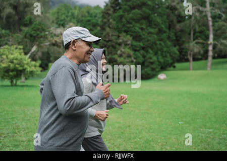 Man and Woman jogging ensemble dans le parc Banque D'Images