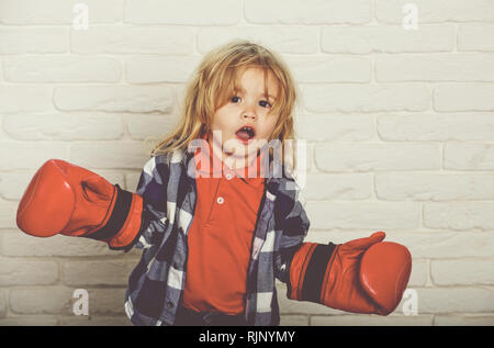 Champion ou heureux petit garçon en rouge gants de boxe, large Banque D'Images