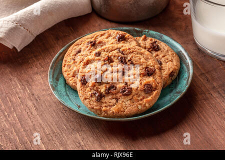 Un gros plan de cookies aux pépites de chocolat au lait sur une table rustique en bois foncé Banque D'Images