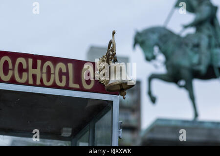 Golden Bell en avant-plan sur la rue à l'ancienne l'étal du vendeur avec statue de cheval et le cavalier à l'arrière-plan flou à Rosario Argentine Banque D'Images