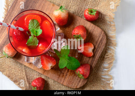 Jus de fraises et de menthe sur le dessus et des fraises fraîches sur une cale en bois, des boissons d'été concept top view Banque D'Images