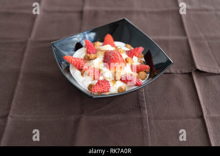 Délicieux yogourt avec fraises rouges frais et de miel sur le dessus Banque D'Images