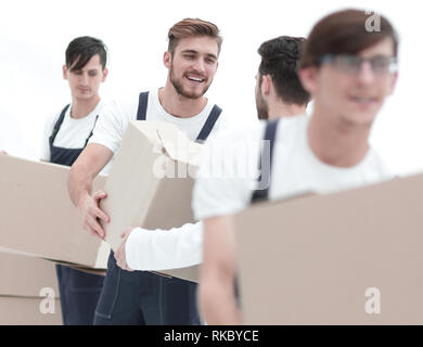 Les travailleurs passent chaque photo autres cases lors du déplacement d'appartements Banque D'Images