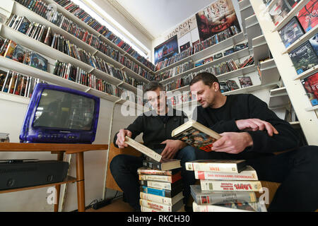 Kassel, Allemagne. 06Th Feb 2019. Ralf Stadler (l) et Christoph Langguth assis devant une pile de cassettes VHS dans le film de Kassel shop. Les deux appartiennent à Randfilm, l'association qui a sauvé la boutique vidéo la plus ancienne d'Allemagne de la destruction il y a plus d'un an. Depuis la reprise par Randfilm Videothek a changé : c'est un mélange de film distribution, musée et lieu culturel. (Dpa 'Verein macht aus Videothek Deutschlands älteste ein Museum' à partir de 11.02.2019) Crédit : Uwe Zucchi/dpa/Alamy Live News Banque D'Images