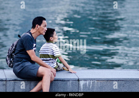 La capture d'un moment de grand-père et petit-fils de passer du temps dans la Marina Bay. Profiter de la vue et se détendre. Banque D'Images