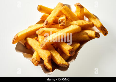 Partie de pommes frites ou chips de pomme de terre frites dans un plat isolé sur blanc vue high angle close up pour la publicité Banque D'Images