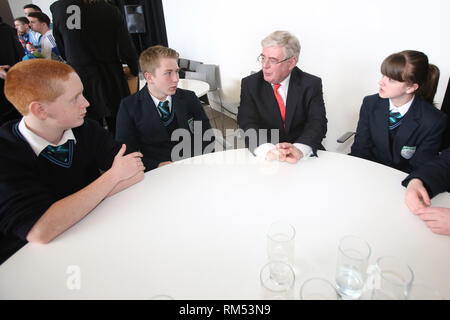 Un vice-Premier ministre irlandais Tánaiste, Eamon Gilmore est à l'écoute des élèves (de gauche à droite) Rory Killen, Christie et Hillerby Hosick Julieanne de Malone College de Belfast, après un petit déjeuner débat marquant le 15ème anniversaire de la signature de l'Accord de Belfast, lundi 29 avril à la MAC. Le Tánaiste a rejoint le secrétaire d'État pour l'Irlande du très honorable Theresa Villiers MP lors de l'événement qui était remplie de jeunes nés en 1998, les jeunes et les organisations communautaires, les chefs d'entreprises et des universitaires. Photo/Paul McErlane Banque D'Images