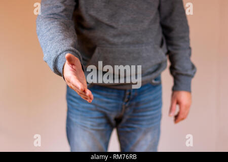 Hand reaching out for a handshake Banque D'Images