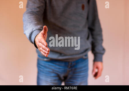 Hand reaching out for a handshake Banque D'Images