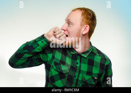 L'homme aux cheveux rouge mordre son poing, main. choqué, caucasien homme adolescent. surpris guy roux crier. Réaction à surprise est heureux de choc. L'émotion est grave, la peur, le stress. Banque D'Images