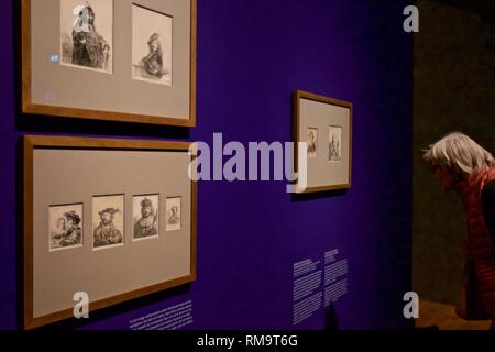 Amsterdam, Pays-Bas. Feb 13, 2019. Un visiteur regarde une peinture au cours de l'aperçu du média de l'exposition 'TOUS' les enfoirés au Rijksmuseum à Amsterdam, Pays-Bas, le 13 février 2019. Rijksmuseum a présenté sa collection de toutes les œuvres de Rembrandt dans l'exposition marquant le 350e anniversaire du peintre hollandais Rembrandt Harmenszoon van Rijn's la mort. Credit : Sylvia Lederer/Xinhua/Alamy Live News Banque D'Images