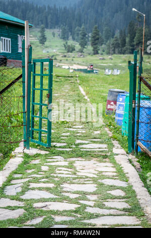 Une entrée ouverte en acier à la clôture d'un resort hut lodge dans les prés du Cachemire Banque D'Images