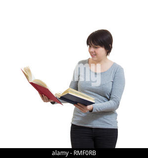 Jeune femme douteuse étudiant ou enseignant tenant deux livres ouverts comparer et choisir l'élément à lire. Décision difficile, faire le bon choix, Banque D'Images