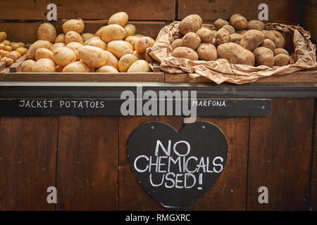 Différentes variétés de pommes de terre biologiques en vente sur un étal dans un marché fermier local. Le format paysage. Banque D'Images