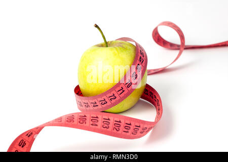 Pomme verte et ruban à mesurer sur fond blanc Banque D'Images