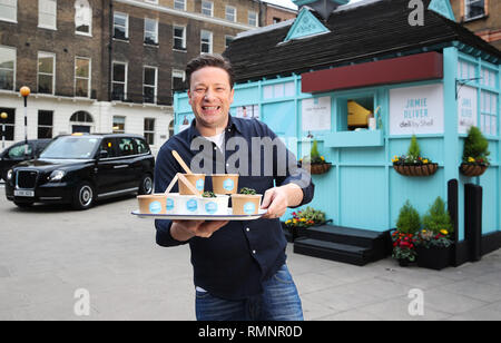 Jamie Oliver teste de nouvelles on-the-go gamme alimentaire à son plus petit eatery jusqu'à ce jour, une maison d'hébergement traditionnel cabmen à Russell Square, d'annoncer le lancement de Jamie Oliver deli par Shell, Londres. Chauffeurs et passants de la queue à un refuge pour cocher traditionnels à Russell Square, à test routier, la nouvelle gamme de Jamie Oliver deli par Shell. Le nouveau menu inclut des en-cas tels que fruits rouges Superfood Hot Pot, porridge, d'Œufs et Bacon Bean Pot chaud, méditerranéen & veggie rôti, un enveloppement à la ricotta fromage fumé et épicé salade sandwich au poulet chipotle de même qu'une nouvelle boîte de repas des enfants qui proposera un ry Banque D'Images