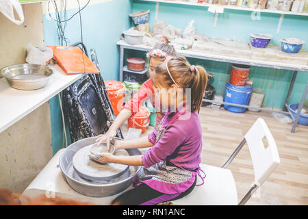 Deux petites filles, l'apprentissage créatif au potter atelier en art studio - Enfant façonner l'argile sur la roue de la poterie Banque D'Images