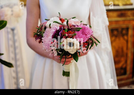 Belle jeune mariée en robe blanche holding bouquet de mariage, bouquet de mariée rose de spray, crème, rose pourpre rose, violet eusto Memory Lane Banque D'Images