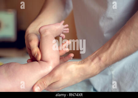 Image de mains d'un massothérapeute faire massage des pieds pour petit enfant Banque D'Images