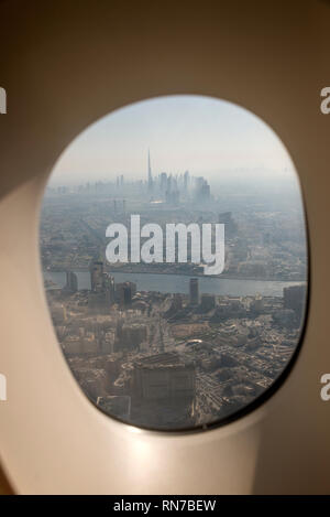 Vue de la fenêtre d'un avion d'une fin d'après-midi d'une épaisse Brume de chaleur au centre-ville de Dubaï et la hauteur 629,8 m Burj Khalifa, connu sous le nom de Burj Dubai à Dubaï, Banque D'Images