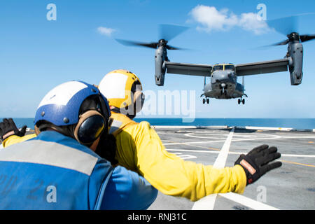 190218-N-DX072-1573 GOLFE DE THAÏLANDE (fév. 18, 2019) - Aviation 4400 Boatwain (manutention) 3e classe Walter Rutherford, de Cheyenne, Wyo., signale à un CV-22 Osprey hélicoptère, affecté à la 353e groupe d'opérations spéciales, comme il atterrit sur le pont du navire de transport amphibie USS dock Green Bay (LPD 20). Green Bay, partie de la Guêpe groupe amphibie, à 31e Marine Expeditionary Unit (MEU), est en Thaïlande pour participer à l'exercice Gold Cobra 2019. Gold Cobra est un exercice multinational co-parrainé par la Thaïlande et les États-Unis qui est conçu pour l'avance reg Banque D'Images