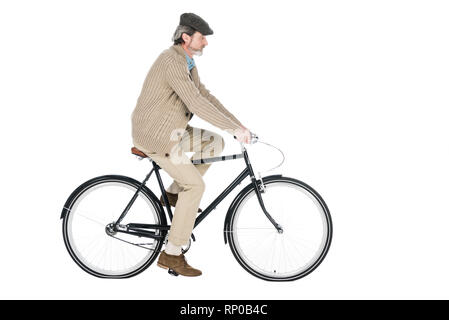 Cheerful pensionné riding bicycle isolated on white Banque D'Images