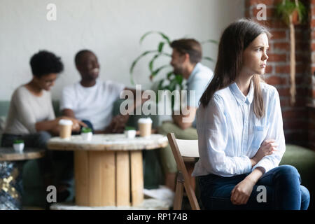 Jeune fille se tient à outcast pairs in cafeteria Banque D'Images