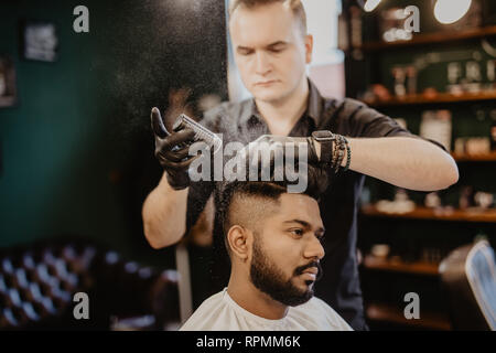 Les barbiers part propagation de la poudre de talc sur les clients professionnels avec cou blaireau en salon de coiffure pour hommes soin de beauté.concept.jeune homme noir ge Banque D'Images