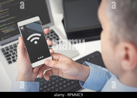 Man using smartphone avec symbole sans fil. Concept de l'internet mobile Banque D'Images