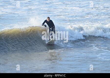 Pays de Galles Aberystwyth UK. Vendredi 22 Fév 2019 UK weather : Surfers appréciant le soleil Février incroyablement chaude à Aberystwyth, sur la côte ouest du pays de Galles. Le temps devrait rester très bien pour les prochains jours avec la possibilité d'enregistrer les températures ont dans certains endroits Crédit photo : Keith morris/Alamy Live News Banque D'Images