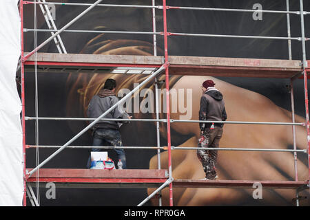 Berlin, Allemagne. Feb 21, 2019. Les pulvérisateurs sur l'échafaud deux compléter l'immense peinture murale de la chambre de l'hôtel East Side. Ce sont les mains de Mona Lisa. Credit : Annette Riedl/dpa/Alamy Live News Banque D'Images